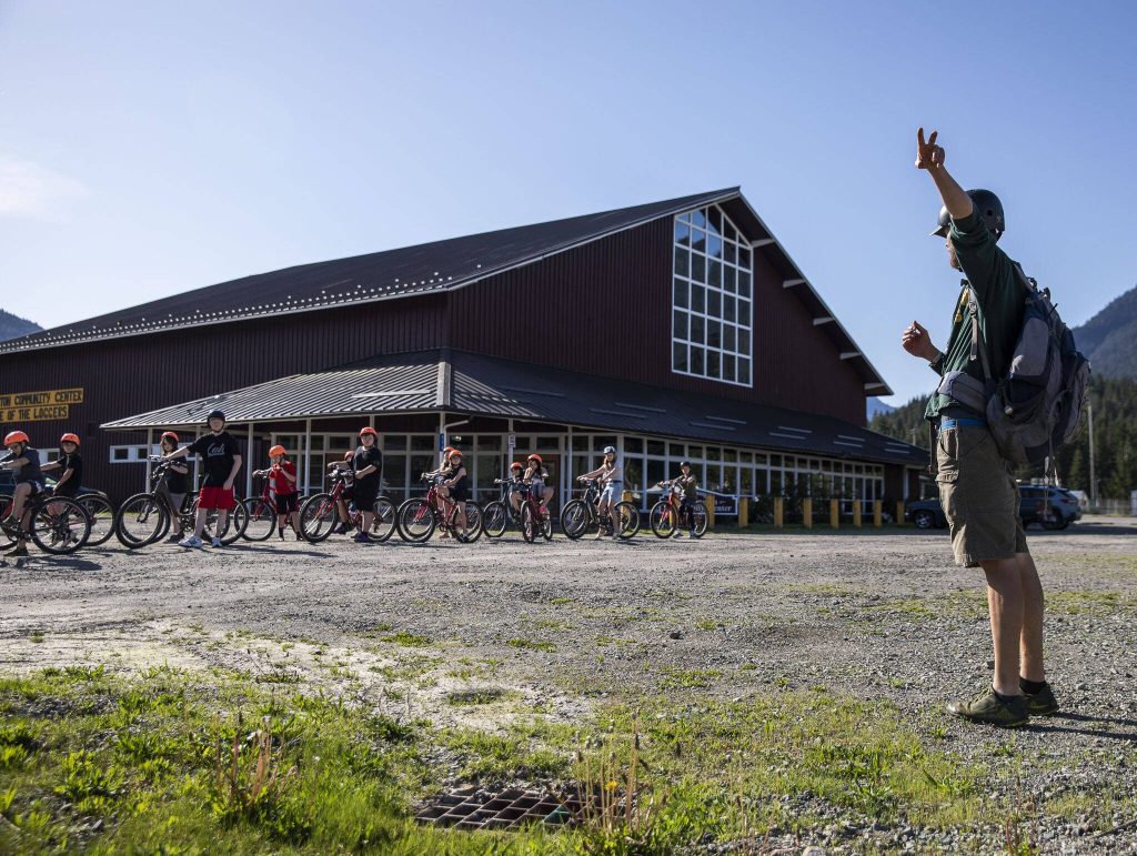 PE teacher Gavin Gladsjo talks his students through a bike safety exercise during class at Darrington Elementary School on Friday, May 12, 2023 in Darrington, Washington. (Olivia Vanni / The Herald)