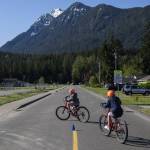 Students make left turns across a road during a bike safety class at Darrington Elementary School on Friday, May 12, 2023 in Darrington, Washington. (Olivia Vanni / The Herald)