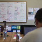 A whiteboard with peoples responsibilities for the day is visible in the Everett Clubhouse on Monday, May 8, 2023 in Everett, Washington. (Olivia Vanni / The Herald)