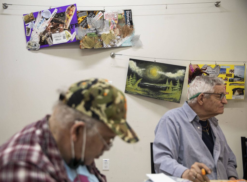 Artwork hangs on the walls in the art studio at the Everett Recovery Cafe on Wednesday, May 10, 2023 in Everett, Washington. (Olivia Vanni / The Herald)