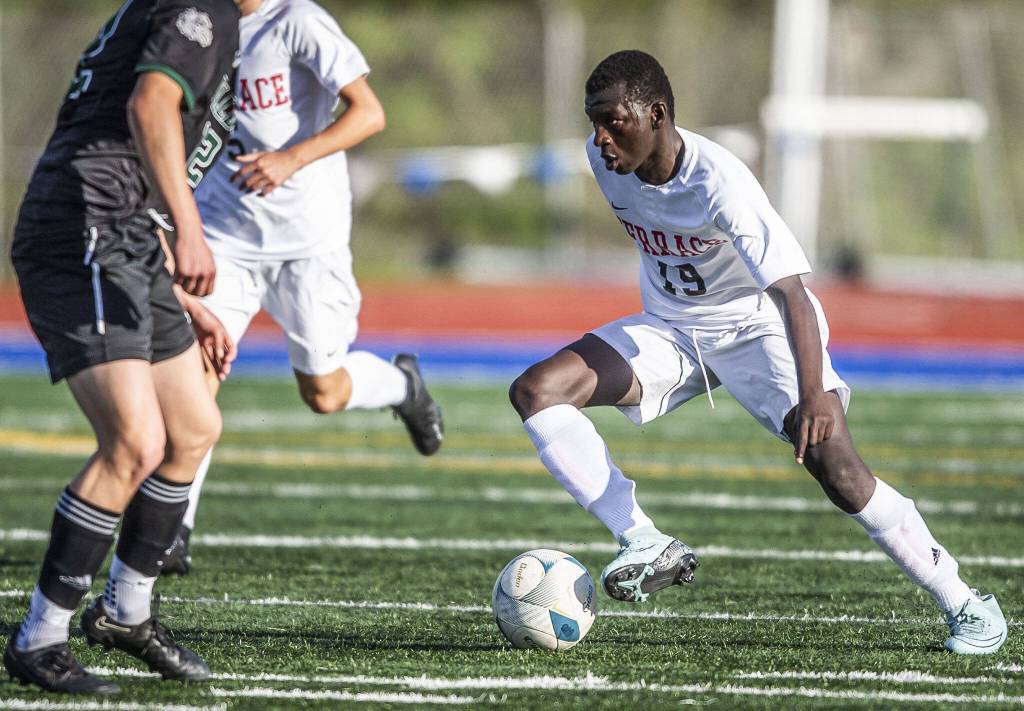 Mountlake Terraces Omar Kongira dribbles the ball around a defender during the game against Mount Vernon on Tuesday, May 9, 2023 in Shoreline, Washington. (Olivia Vanni / The Herald)