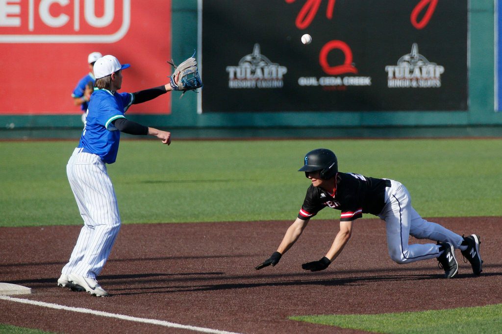 Shorewoods Evan Hjort catches a ball at third to tag out a Mountlake Terrace runner in a Wesco 3A District 1 semifinal on Tuesday, May 9, 2023, at Funko Field in Everett, Washington. (Ryan Berry / The Herald)
