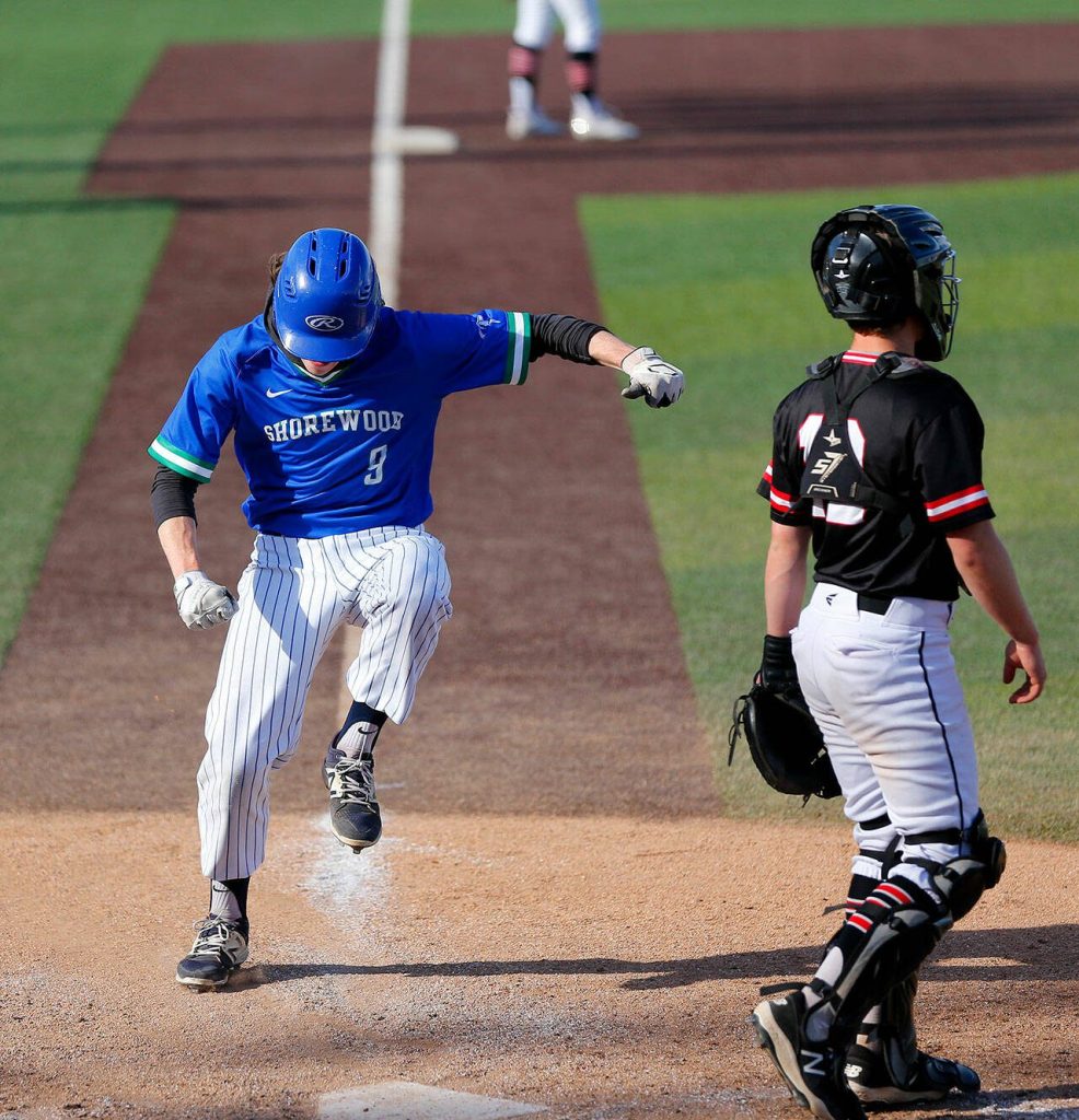Shorewoods Noah Fahey stomps on home plate to score the go-ahead run against Mountlake Terrace in a Wesco 3A District 1 semifinal on Tuesday, May 9, 2023, at Funko Field in Everett, Washington. (Ryan Berry / The Herald)