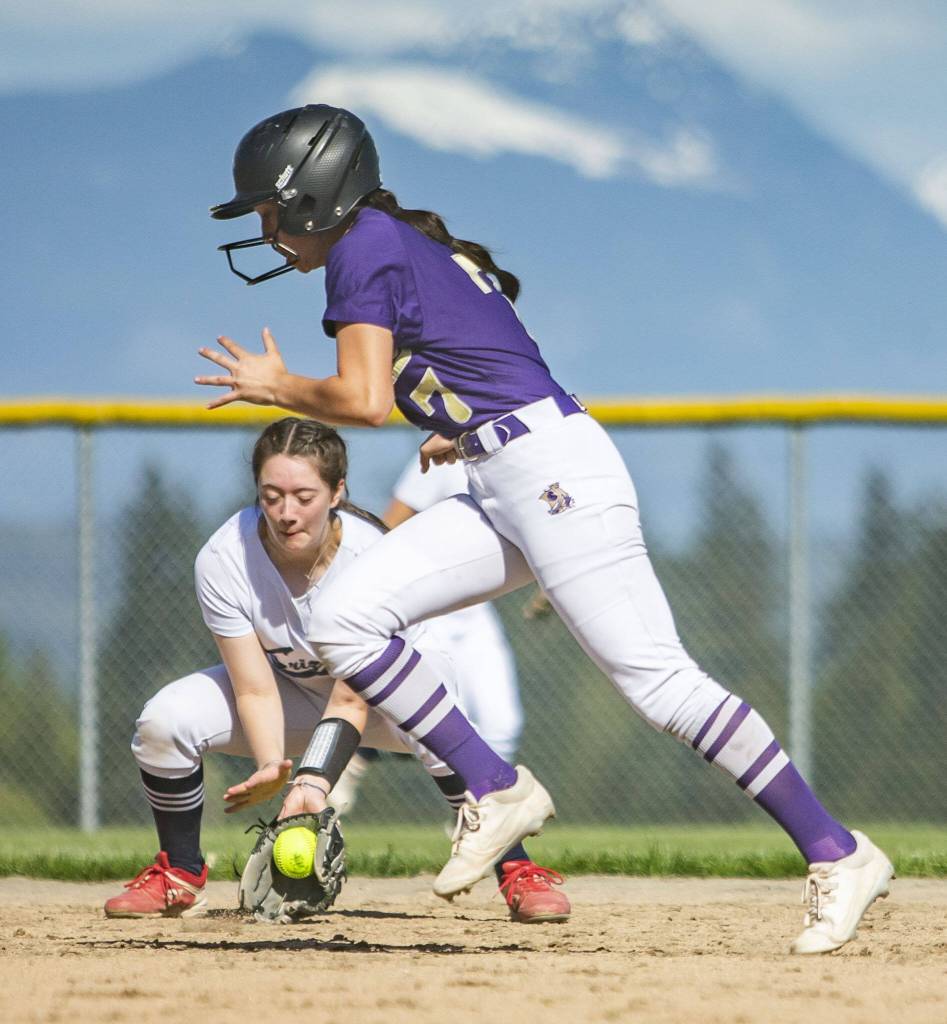 Glacier Peaks Lauren Hufford fields the ball while Lake Stevens Haylee Kim runs past during a game on Wednesday, May 10, 2023, in Snohomish, Washington. (Olivia Vanni / The Herald)