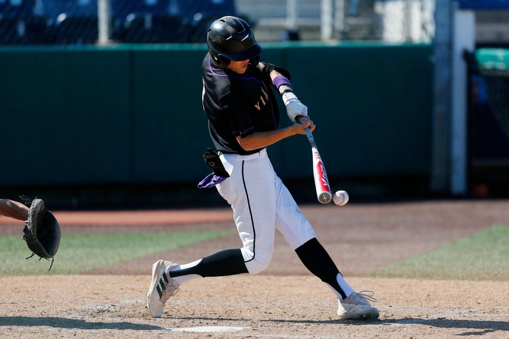 Lake Stevens Seth Mahler hits a hard grounder to the left side against Jackson during a Wesco 4A District 1/2 game on Thursday, May 11, 2023, at Funko Field in Everett, Washington. (Ryan Berry / The Herald)