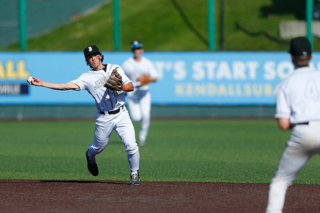 Jacksons Evan Mothersbaugh throws out a Lake Stevens baserunner at first during a Wesco 4A District 1/2 game on Thursday, May 11, 2023, at Funko Field in Everett, Washington. (Ryan Berry / The Herald)