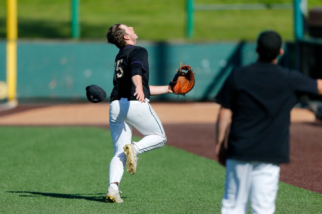 Lake Stevens first baseman Cody Osterholtz loses his cap while chasing a popup in foul territory against Jackson during a Wesco 4A District 1/2 game on Thursday, May 11, 2023, at Funko Field in Everett, Washington. (Ryan Berry / The Herald)