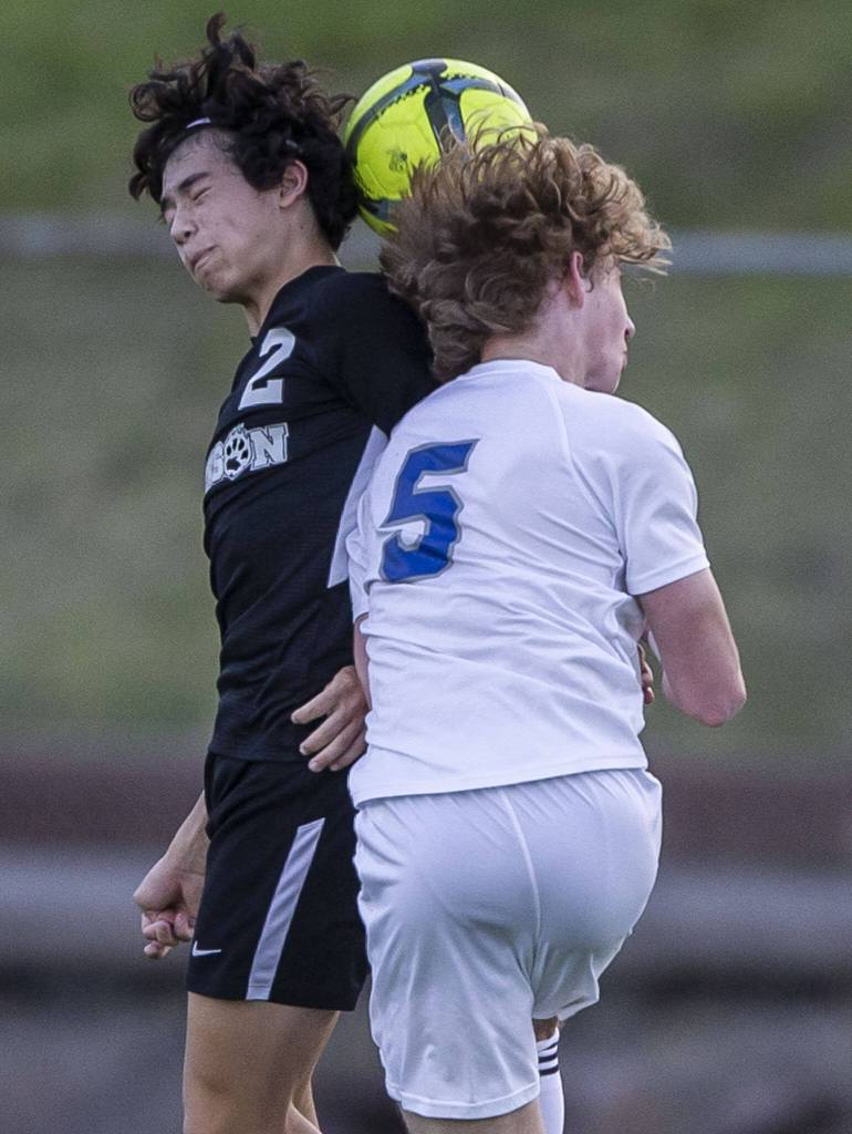 Jacksons Brady McPherson and Bothells Emery Weaver both jump up for a head ball during the game on Thursday, May 11, 2023 in Everett, Washington. (Olivia Vanni / The Herald)
