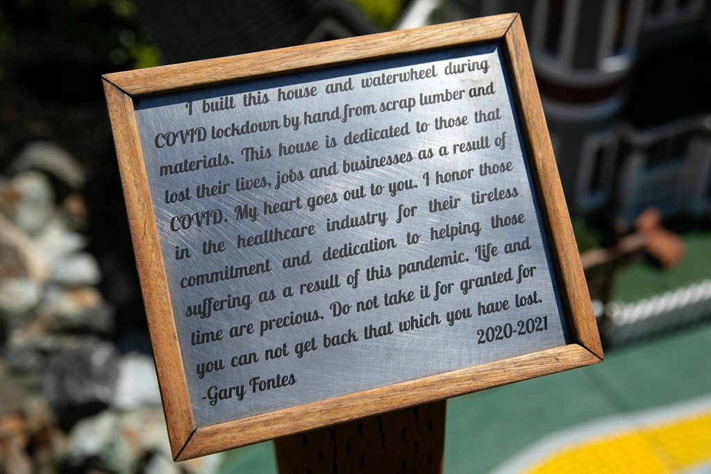 A sign written by Gary Fontes is placed in front of one of his model homes on Friday, May 12, 2023, at his home near Silver Lake in Everett, Washington. (Ryan Berry / The Herald)
