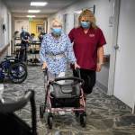 CNA Nina Prigodich, right, goes through restorative exercises with long term care patient Betty Long, 86, at Nightingale's View Ridge Care Center on Friday, Feb. 10, 2023 in Everett, Washington. (Olivia Vanni / The Herald)