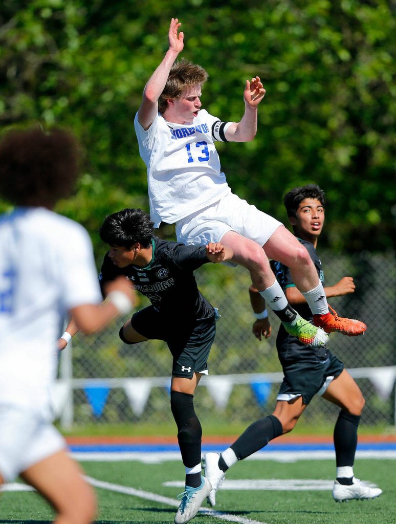 Shorewoods Blaise Clapper takes to the air to head the ball up the field against Mount Vernon during the 3A District Championship match on Saturday, May 13, 2023, at Shoreline Stadium in Shoreline, Washington. (Ryan Berry / The Herald)