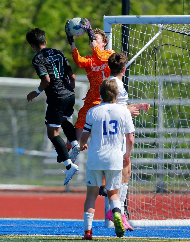 Shorewood goalie Conner Cann takes hold of a cross to the net against Mount Vernon during the 3A District Championship match on Saturday, May 13, 2023, at Shoreline Stadium in Shoreline, Washington. (Ryan Berry / The Herald)