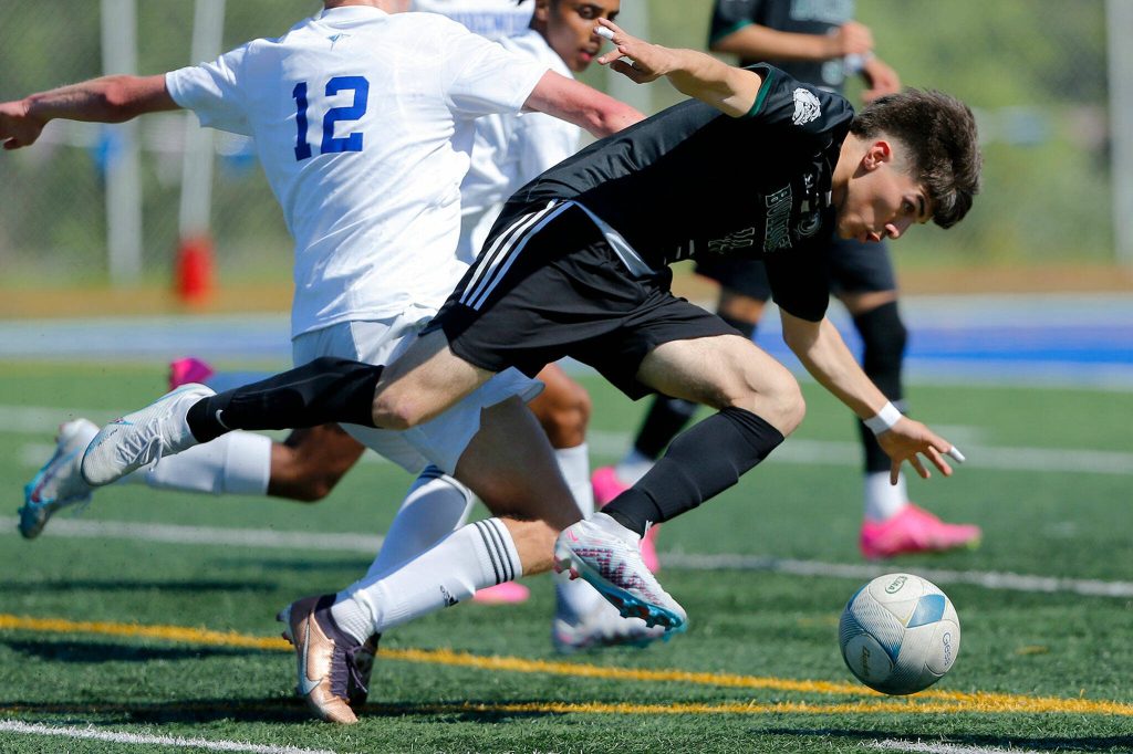 Mount Vernons Jonathan Mancillas-Garduno tries to retain possession of the ball against Shorewood during the 3A District Championship match on Saturday, May 13, 2023, at Shoreline Stadium in Shoreline, Washington. (Ryan Berry / The Herald)