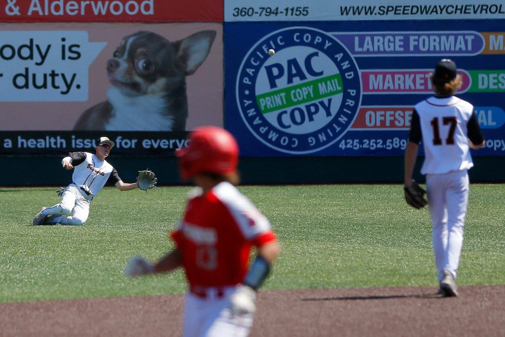 Monroe center fielder Eli Miller makes a diving catch to win the game against Stanwood in a winner-to-state consolation game on Saturday, May 13, 2023, at Funko Field in Everett, Washington. (Ryan Berry / The Herald)
