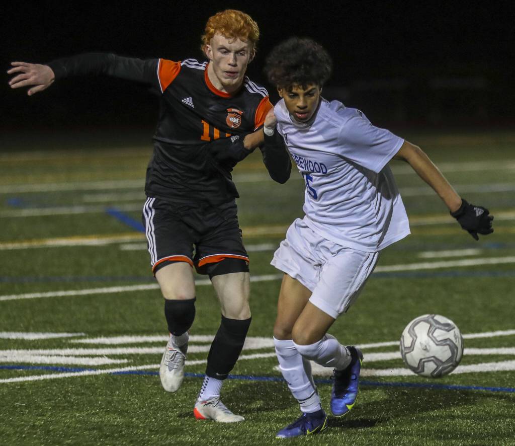 Monroes Nolan Kelly (10) and Shorewoods Matthew Bereket (15) fight for the ball during a game at Monroe High School on April 7. (Annie Barker / The Herald)