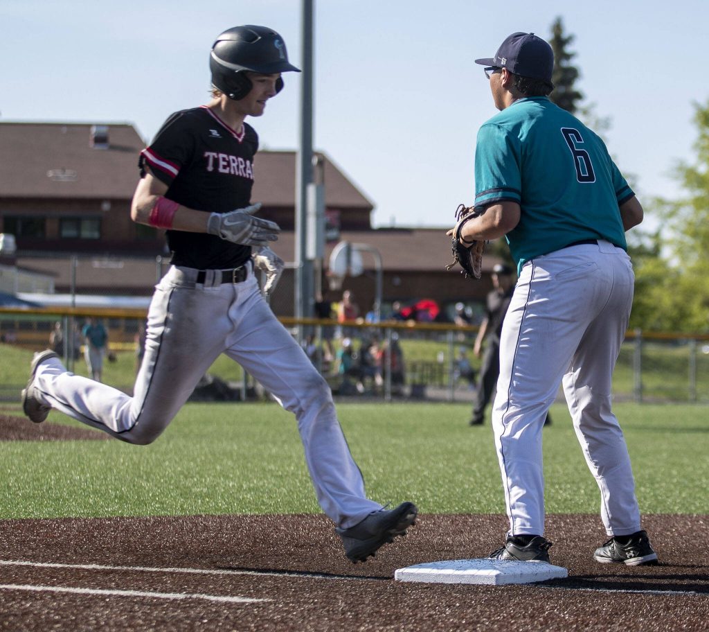 Mountlake Terraces Ryan Sturgill (3) secures a run during a game between Mountlake Terrace and Auburn Riverside in Mountlake Terrace, Washington on Tuesday, May 16, 2023. Mountlake Terrace won, 13-3. (Annie Barker / The Herald)