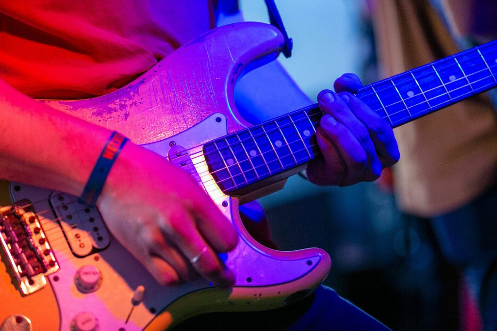 A guitarist keeps rhythm during Lovely Colours set on the opening night of Fishermans Village on Thursday, May 18, 2023, at Black Lab in Everett, Washington. (Ryan Berry / The Herald)