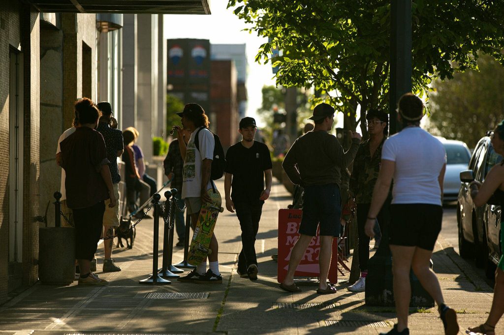 People begin to file into Lucky Dime during the early shows of opening night of Fishermans Village on Thursday, May 18, 2023, in downtown Everett, Washington. (Ryan Berry / The Herald)