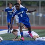 Shorewoods Anthony Henry leaps over a slide tackle during the game against Ballard on Thursday, May 18, 2023 in Shoreline, Washington. (Olivia Vanni / The Herald)