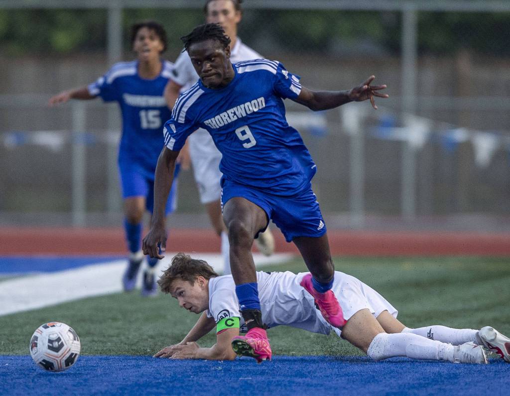 Shorewoods Anthony Henry leaps over a slide tackle during the game against Ballard on Thursday, May 18, 2023 in Shoreline, Washington. (Olivia Vanni / The Herald)