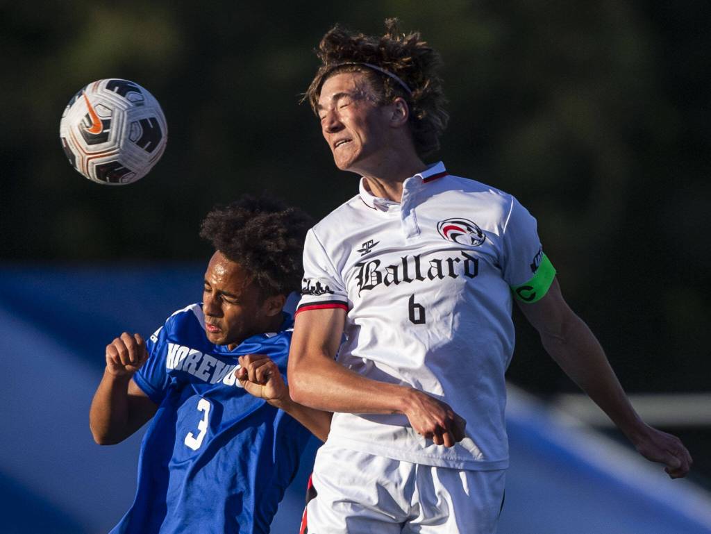 Shorewoods Isaak Abraham leaps in the air for a head ball during the game against Ballard on Thursday, May 18, 2023 in Shoreline, Washington. (Olivia Vanni / The Herald)