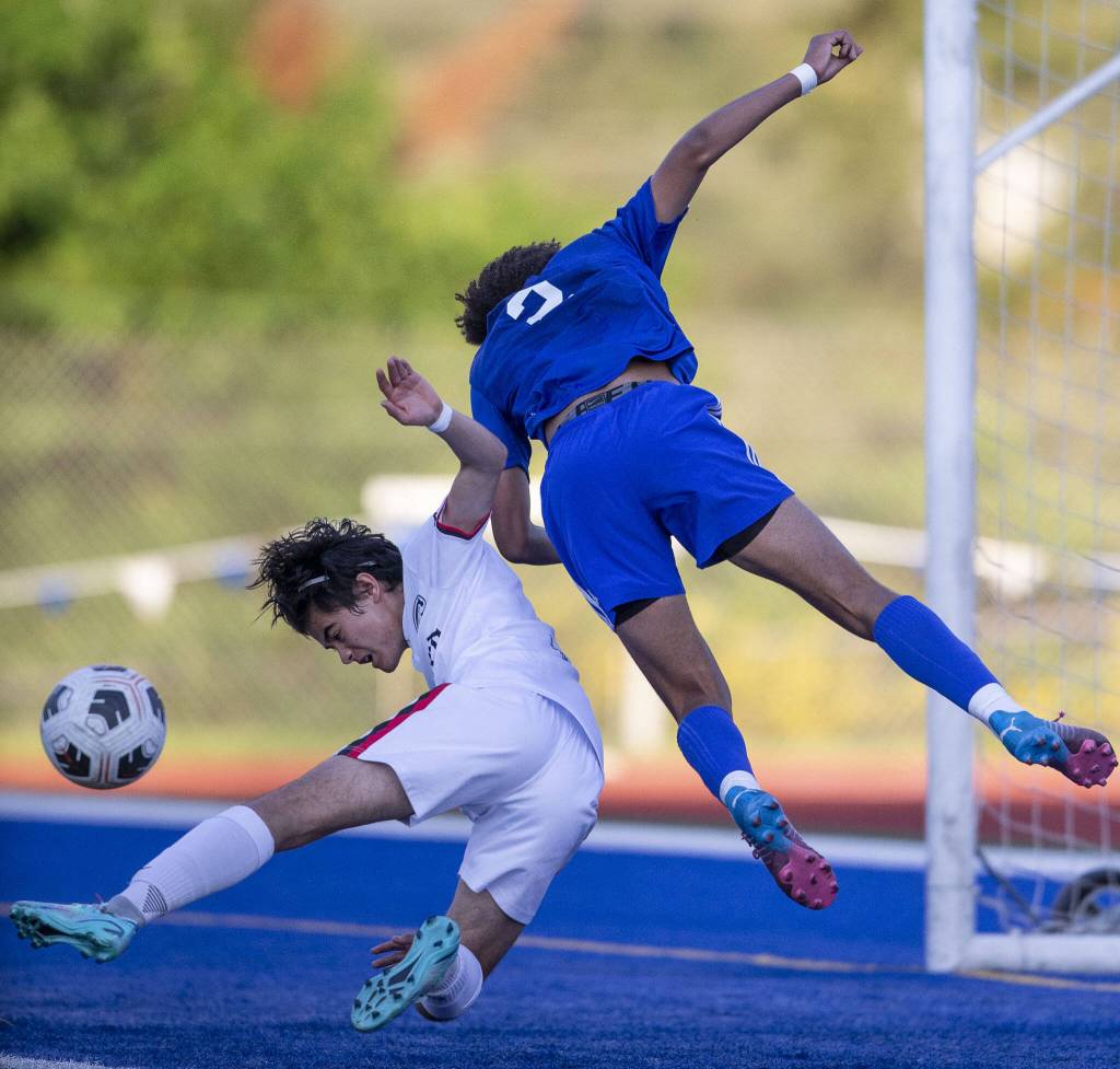 Shorewoods Jackson Smith leaps in the hair for a head ball in front of the goal during the game against Ballard on Thursday, May 18, 2023 in Shoreline, Washington. (Olivia Vanni / The Herald)