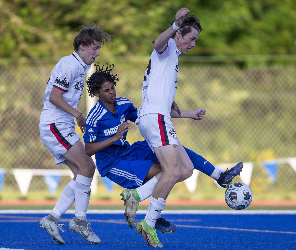 Shorewoods Matthew Bereket is knocked down as he tries to get a shot off in the goal box during the game against Ballard on Thursday, May 18, 2023 in Shoreline, Washington. (Olivia Vanni / The Herald)