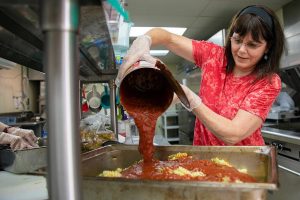 Penelope Protheroe, President and Founder of Angel Resource Connection puts together a huge batch of rotini with meatballs and marinara before heading out to distribute the food and other supplies on Wednesday, May 17, 2023, around Everett, Washington. ARC uses the Lake Stevens Senior Center kitchen to cook up meals for people without homes. (Ryan Berry / The Herald)
