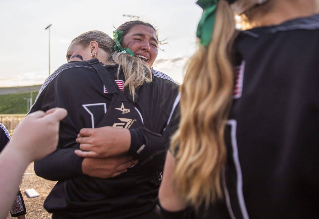 Jacksons Yanina Sherwood cries while hugging catcher and teammate Leneyah Mitchell after beating Bothell to become the 3A district champions on Friday, May 19, 2023 in Everett, Washington. (Olivia Vanni / The Herald)