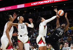 Storm guard Jewell Loyd (24) has her shot blocked by Aces forward Alysha Clark (7) as forward Aja Wilson (22) and forward Candace Parker look on during the first half of a game Saturday in Seattle. (AP Photo/Lindsey Wasson)