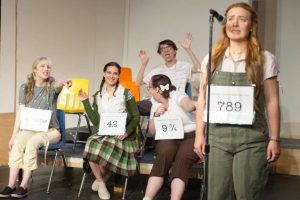 789_speller: Olive Ostrovsky (played Abby Price) concentrates on her spelling word while her competitors, played by (from left) Amanda Petrowski, Alexa Soriano, Haylie Conchelos, and (back row) Jackson Zimmerman try to distract her in “The 25th Annual Putnam County Spelling Bee,” running May 26-June 11 at Red Curtain Arts Center in Marysville.(Kenny Randall)