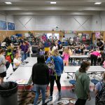 Students, teachers, parents and first responders mill about and snack on pancakes and waffles during a free pancake breakfast at Lowell Elementary School on Friday, May 26, 2023, in Everett, Washington. (Ryan Berry / The Herald)