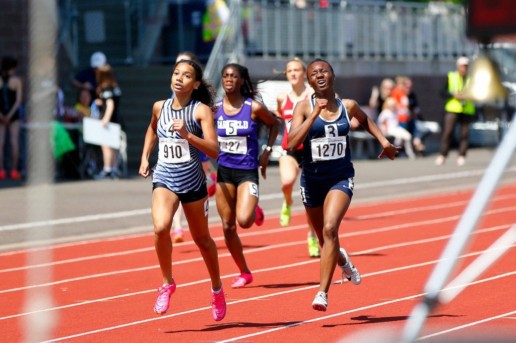 Meadowdale senior Tresley Love, right, fights to hold second place in the 3A girls 400 meter dash during the WIAA State Track and Field Championships on Saturday, May 27, 2023, at Mount Tahoma High School in Tacoma, Washington. (Ryan Berry / The Herald)