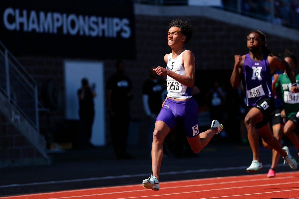 Lake Stevens Grant Buckmiller takes a peek at the clock as he runs to the title in the 4A boys 200 meter dash during the WIAA State Track and Field Championships on Saturday, May 27, 2023, at Mount Tahoma High School in Tacoma, Washington. (Ryan Berry / The Herald)