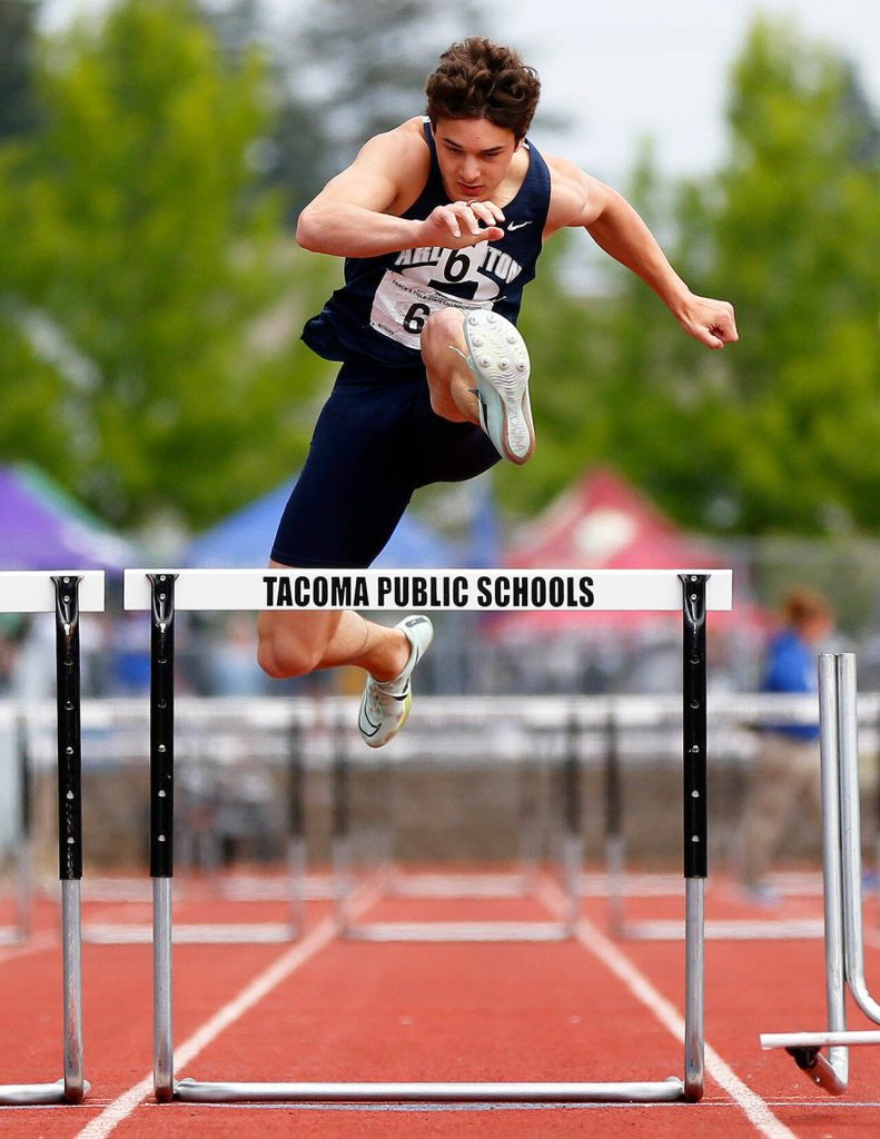 Arlington senior Ryan Rushton clears the last hurdle in the 3A boys 300 meter hurdles during the WIAA State Track and Field Championships on Saturday, May 27, 2023, at Mount Tahoma High School in Tacoma, Washington. (Ryan Berry / The Herald)