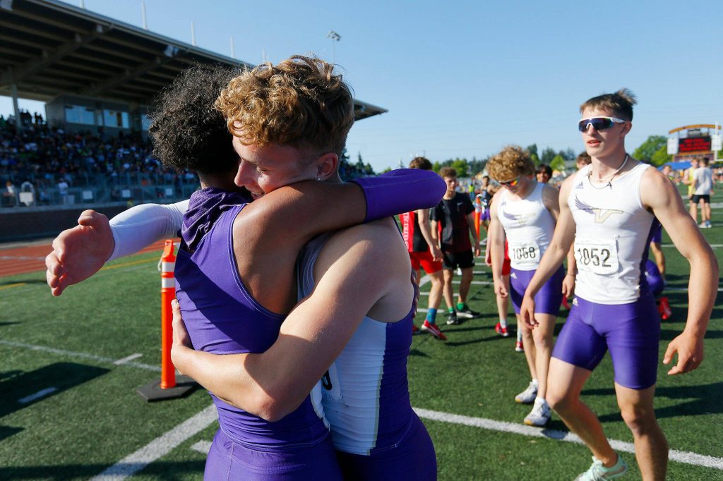 The Lake Stevens boys 4x400 meter relay team begin to hug after claiming the title during the WIAA State Track and Field Championships on Saturday, May 27, 2023, at Mount Tahoma High School in Tacoma, Washington. (Ryan Berry / The Herald)