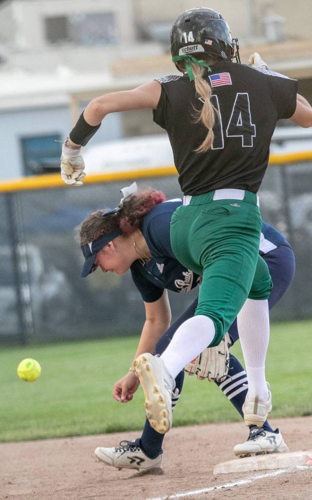 Jacksons Macie Dean (14) hits a ball past first base and Katelyn McCallum (24) during the WIAA Class 4A state softball title game on Saturday, May 27, 2023, in Richland. (TJ Mullinax / For The Herald)