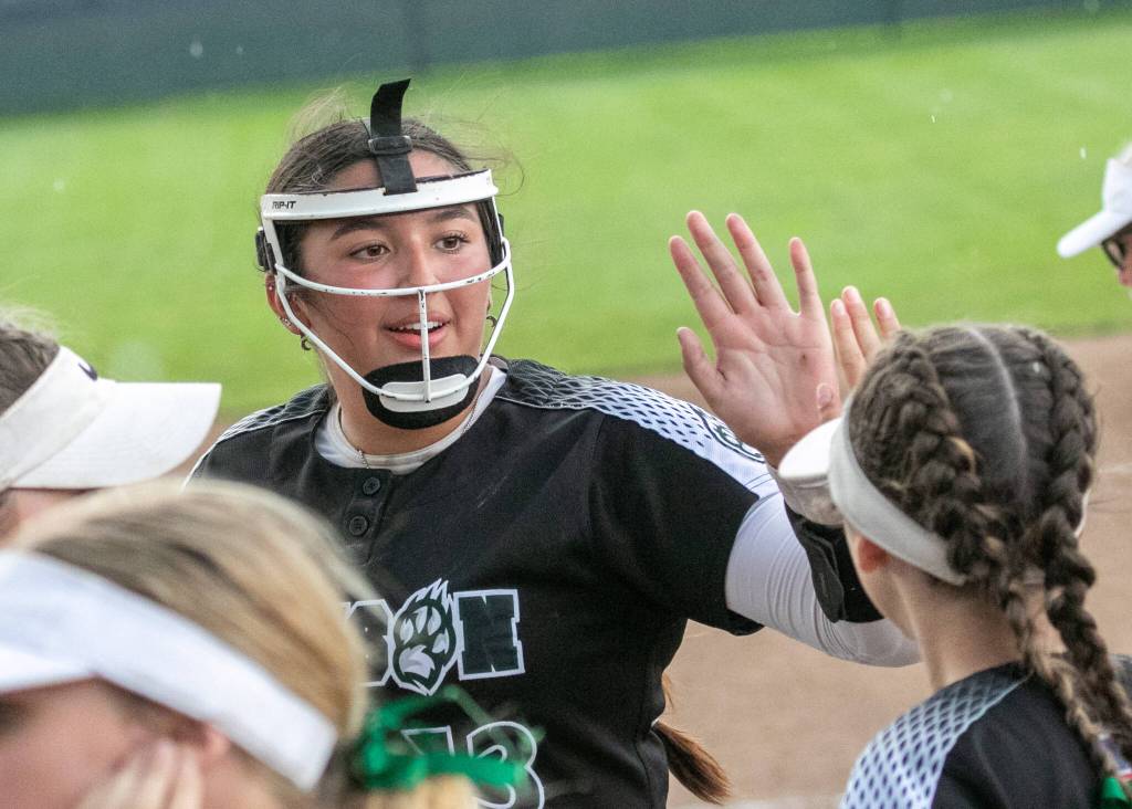Jacksons Yanina Sherwood (13) celebrates with her team after getting an out during the WIAA Class 4A state softball title game on Saturday, May 27, 2023, in Richland. (TJ Mullinax / For The Herald)