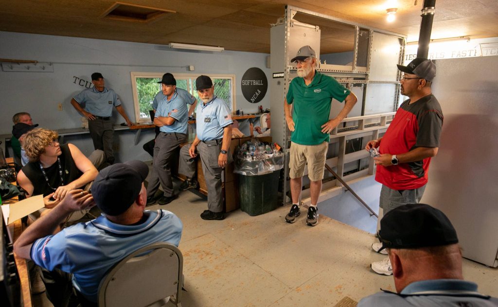 Washington state softball officials discuss shutting down the tournament shortly after lightning and rain halts the WIAA Class 4A state softball title game on Saturday, May 27, 2023, in Richland. (TJ Mullinax / For The Herald)