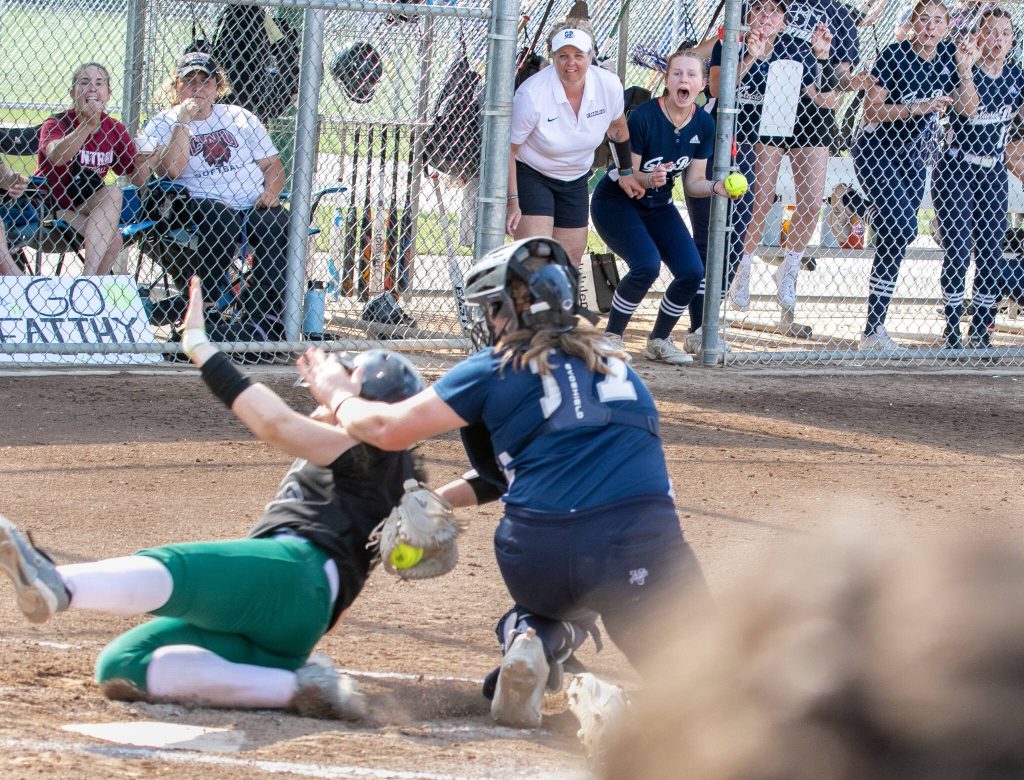 Glacier Peak coach Stefanie Celix and player Aubree Orr (11) watch as catcher Briannica Titus (17) tags out a Jackson player at the plate during the WIAA Class 4A state softball title game on Saturday, May 27, 2023, in Richland. (TJ Mullinax / For The Herald)