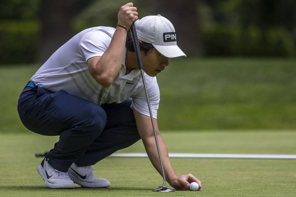 Alvin Kwak sets up his ball during the Snohomish County Amateur golf tournament at the Everett Golf and Country Club in Everett, Washington on Monday, May 29, 2023. (Annie Barker / The Herald)