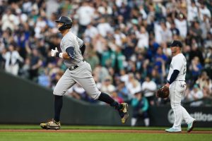 The Yankees Aaron Judge jogs the bases after hitting his second home run of the game a Mariners first baseman Ty France looks on during the sixth inning of a game Monday in Seattle. (AP Photo/Lindsey Wasson)