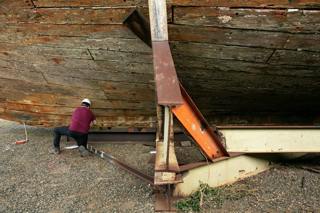 Graduate student Raul Palomino works on taking measurements near the bow of the Equator on Wednesday, June 7, 2023, during a two-week survey of the vessel at its resting place in Everett, Washington. (Ryan Berry / The Herald)
