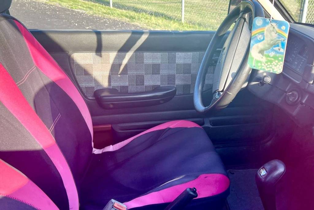 The interior of the “Pork Chop Express". Owner Dave "Bronco" Erickson is seeking to re-home the car for $500, which includes the pictured unicorn air freshener. (Andrea Brown / The Herald)