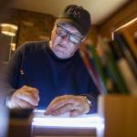 Brian Basset, creator of Red and Rover, works on an upcoming Sunday comic in his studio on Wednesday, June 7, 2023, in Edmonds, Washington. (Olivia Vanni / The Herald)