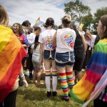 People gather for a color throw at Stanwood and Camanos first-ever Pride celebration on Saturday, June 4, 2022. (Olivia Vanni / The Herald)