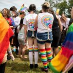 People gather for a color throw at Stanwood and Camano’s first-ever Pride celebration on Saturday, June 4, 2022. (Olivia Vanni / The Herald)