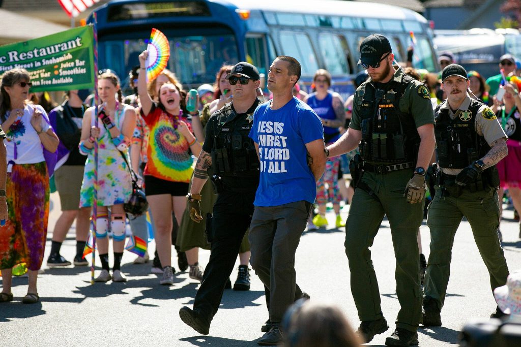 A person is arrested prior to the parade during Snohomishs inaugural Pride celebration on Saturday, June 3, 2023, in downtown Snohomish, Washington. (Ryan Berry / The Herald)