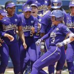 Washington celebrates a home run by Rylee Holtorf (3) at home plate during the second inning of an NCAA softball Women's College World Series game against Utah Friday, June 2, 2023, in Oklahoma City. (AP Photo/Nate Billings)