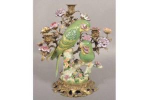 With its ornate brass and painted porcelain features, this candelabrums primary purpose is decoration, not illumination. By the time it was made, improved forms of lighting like oil lamps and electric lights were available.